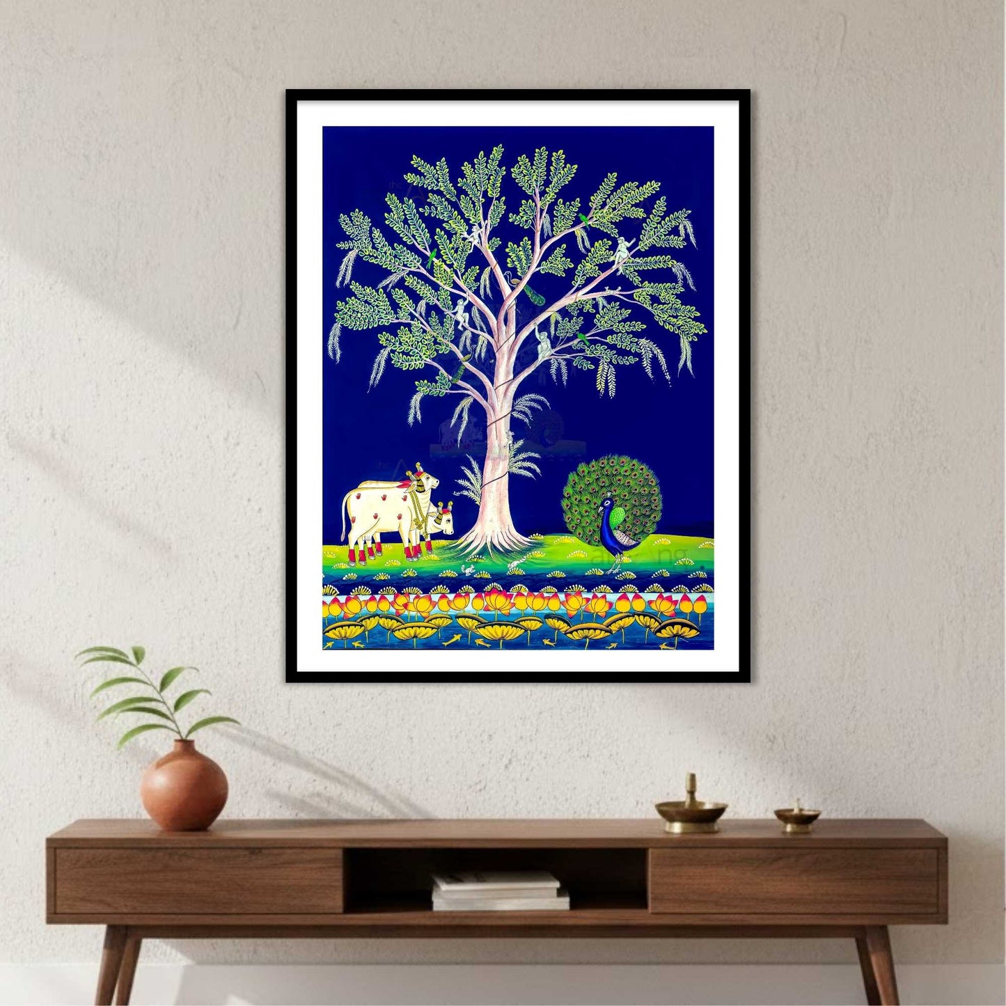 Framed artwork of a tree with animals on a blue background, displayed on a wall for vastu decor.