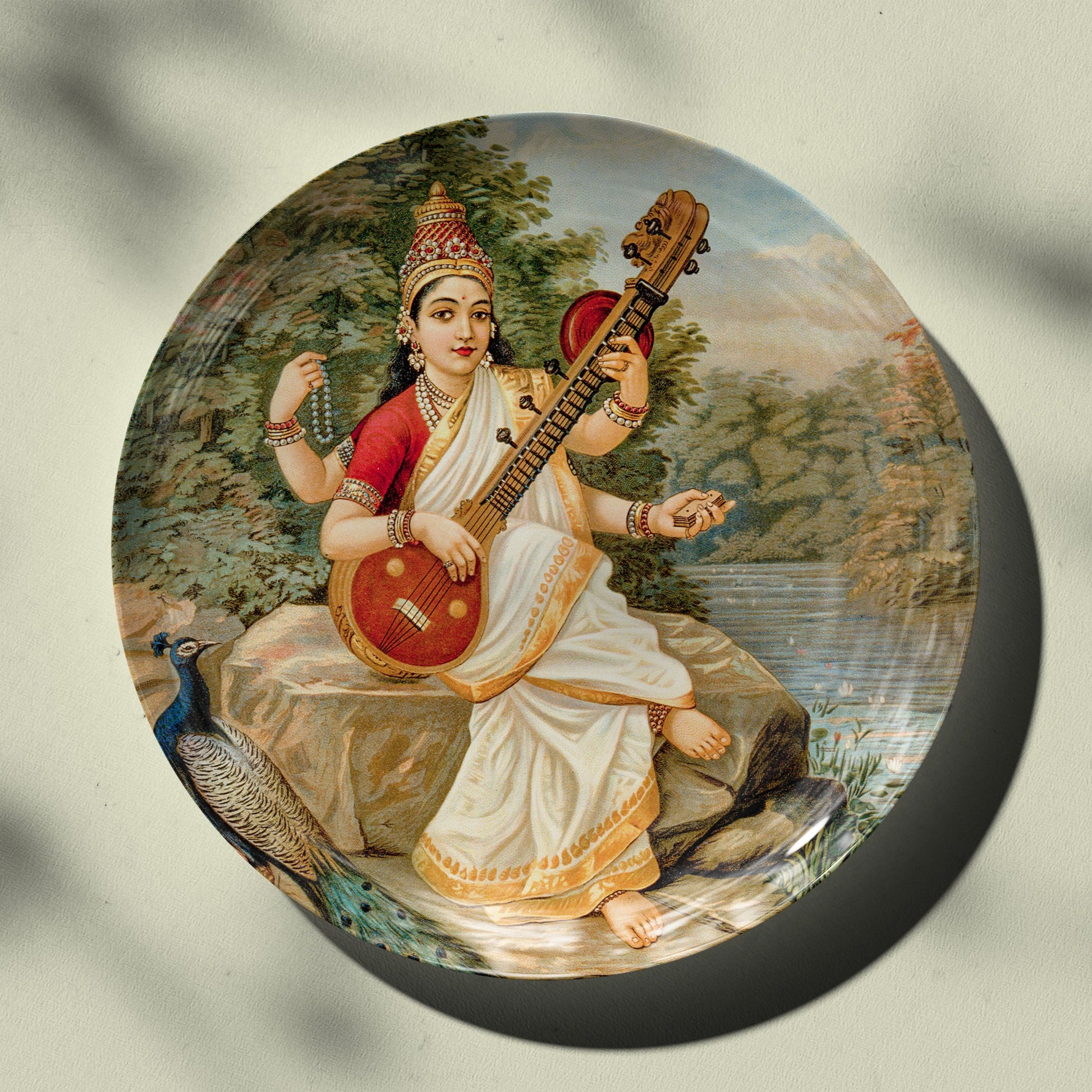 Goddess Saraswati by raja ravi Varma Wall Decor Plate by the Atrang for Indian homes available in 2 sizes and comes with stand and hook 